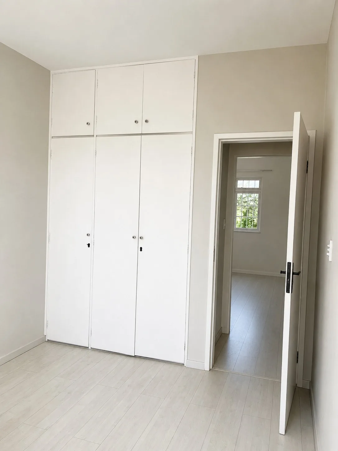 Suíte com armários embutidos do apartamento no bairro Santa Rosa, com acesso ao corredor íntimo.